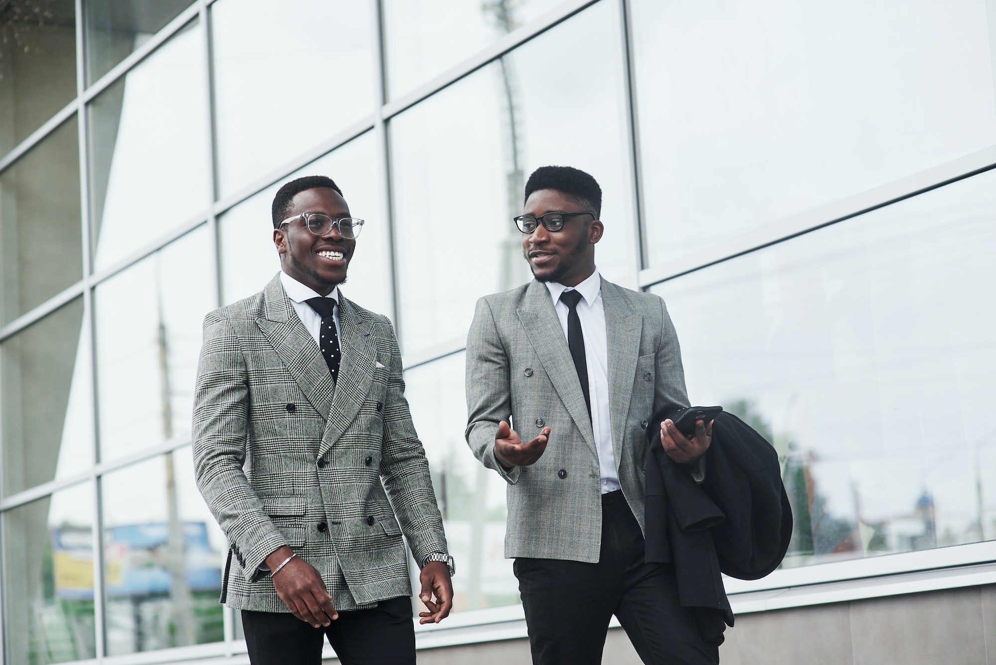 The image of two African American businessmen goes to a meeting in the office