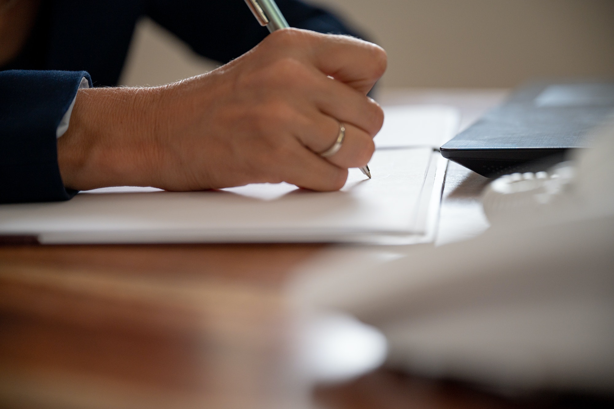 Caucasian businesswoman or lawyer writing a report or document with a pen