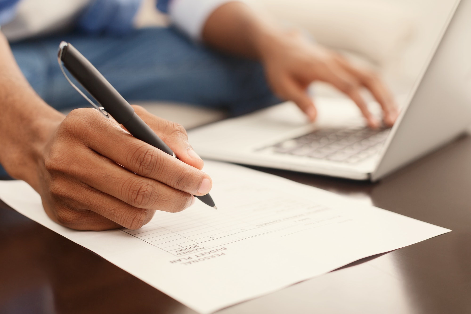 Financier making annual financial report using laptop