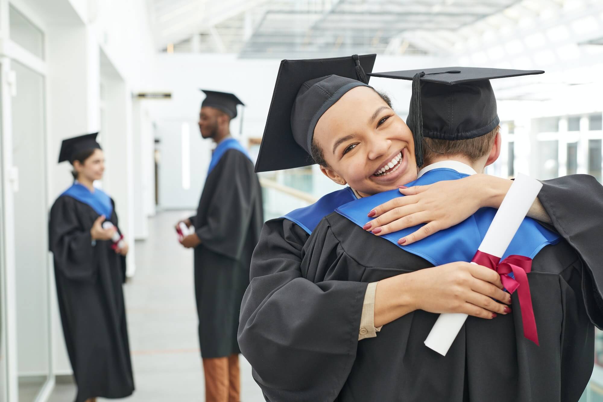 Happy young woman at graduation ceremony