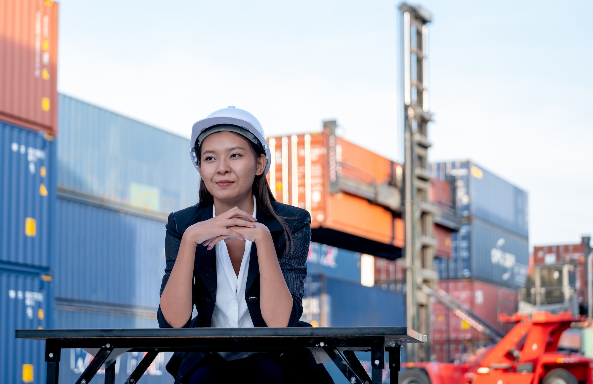 Portrait of engineer worker of factory technician with Chinese woman style sit in cargo area